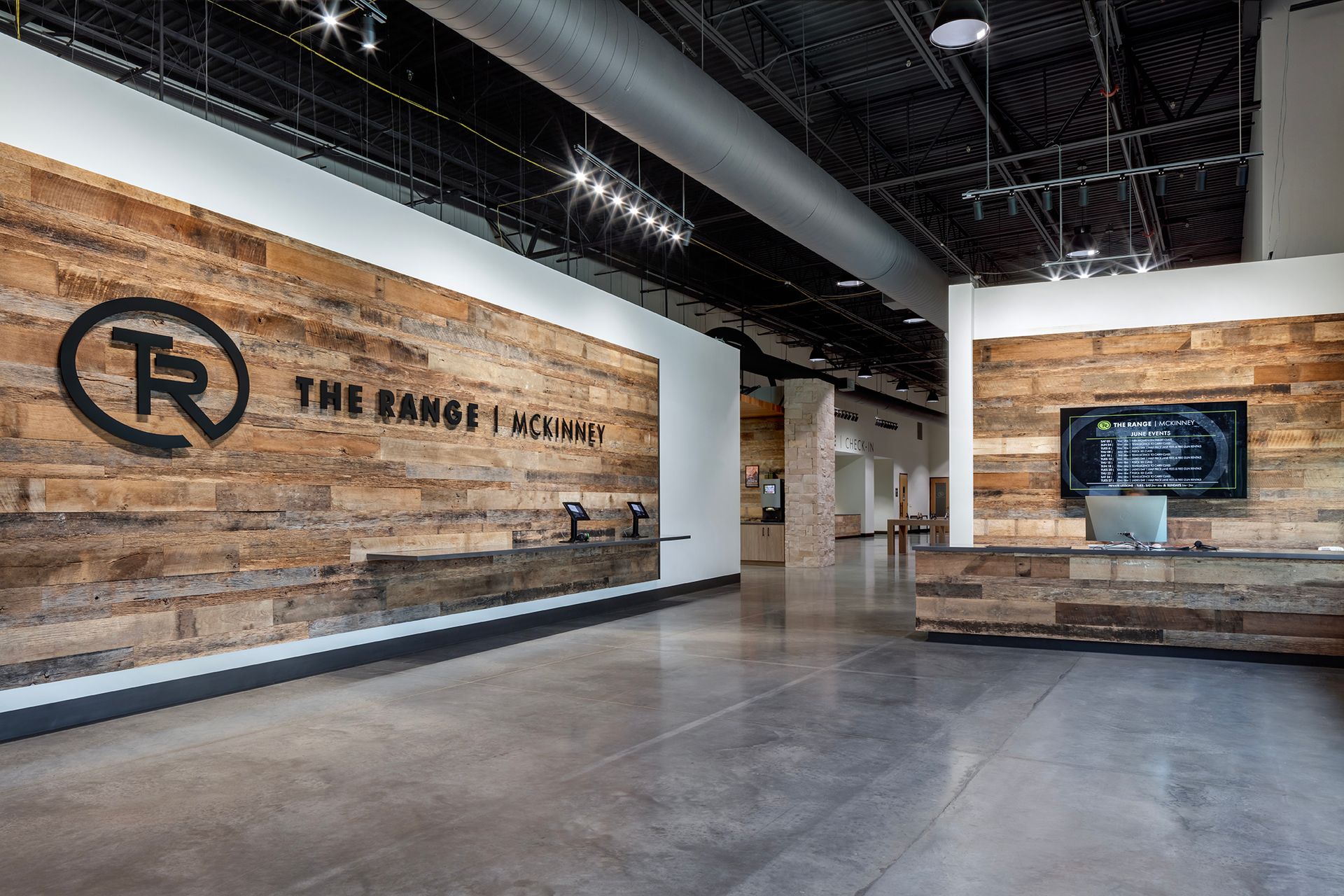 Entry hallway with the TR logo on a wood accent wall