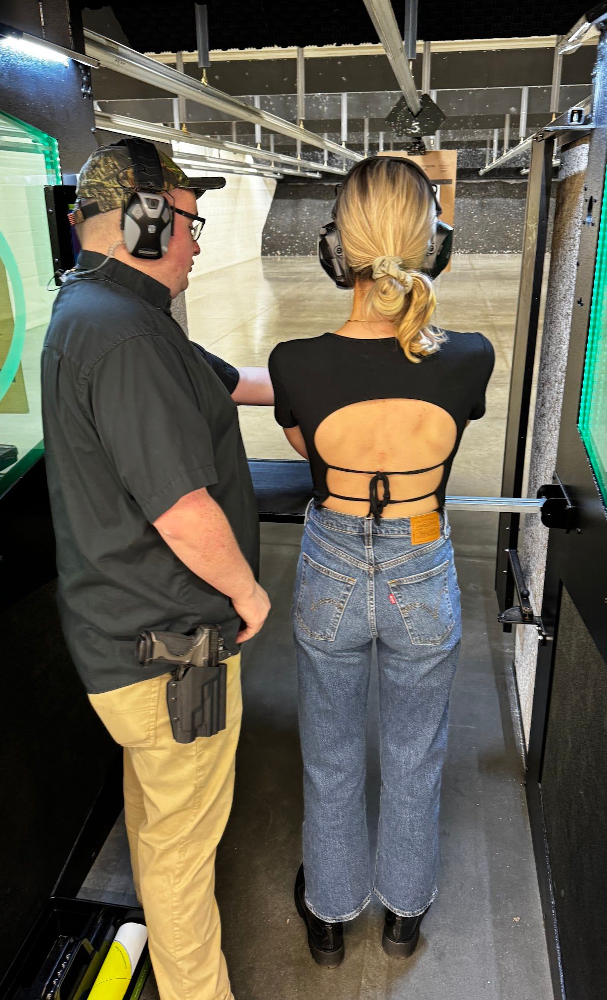 Instructor coaching a student at an indoor lane
