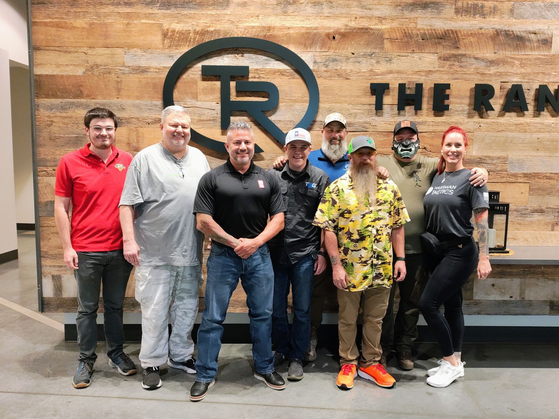 Group photo at The Range in McKinney logo wall
