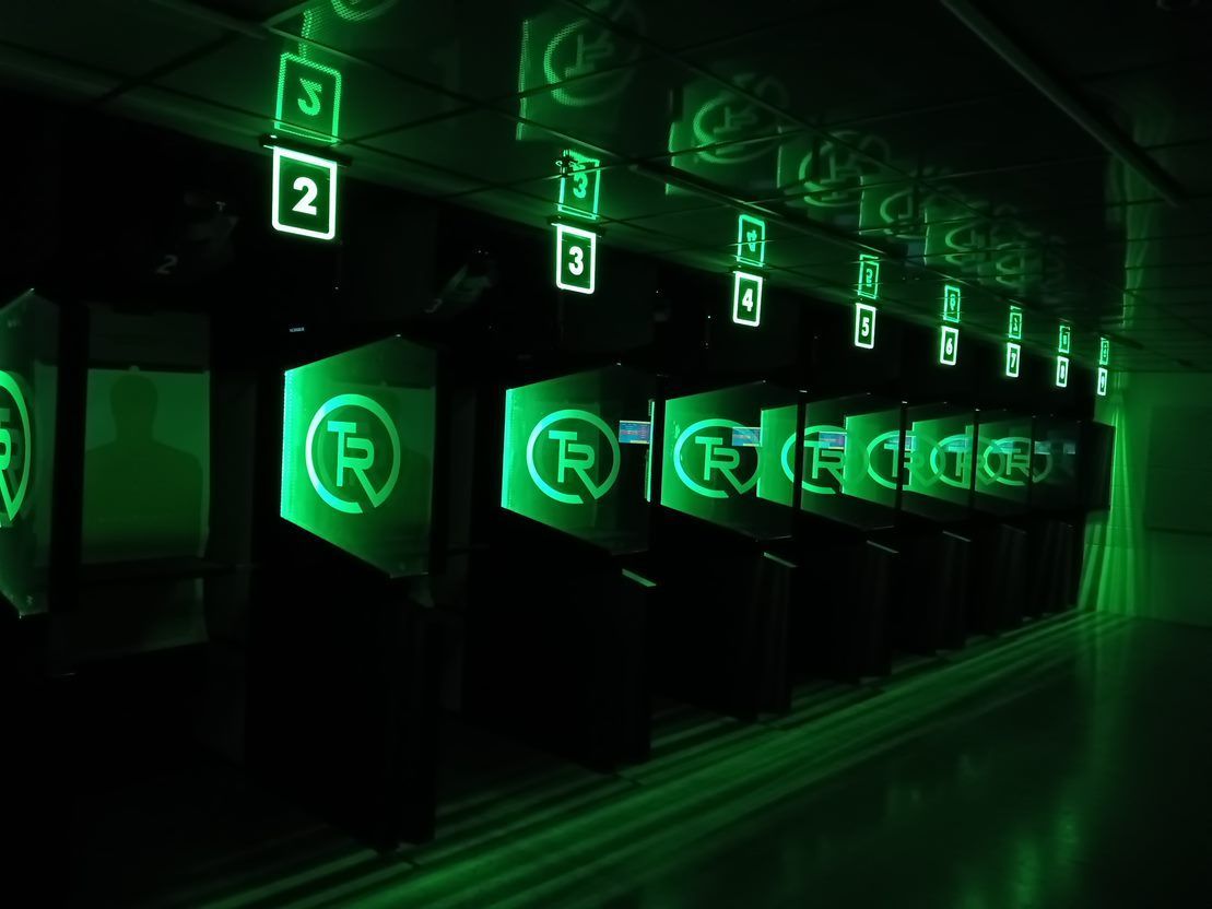 Green blacklight lanes with glowing TR logos
