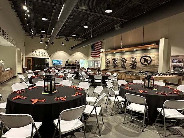 Event space with round tables at a shooting range