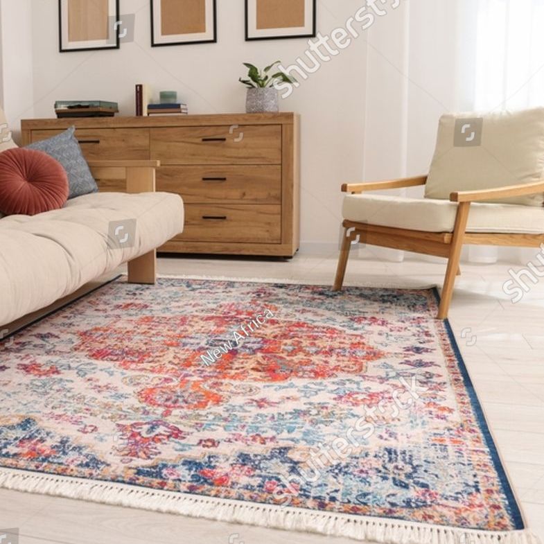 Living room with a patterned rug, wooden furniture, and a cream-colored sofa and armchair.