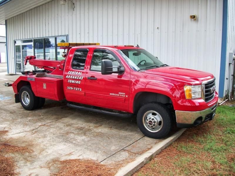 Red General Parkway towing truck parked outside a building.