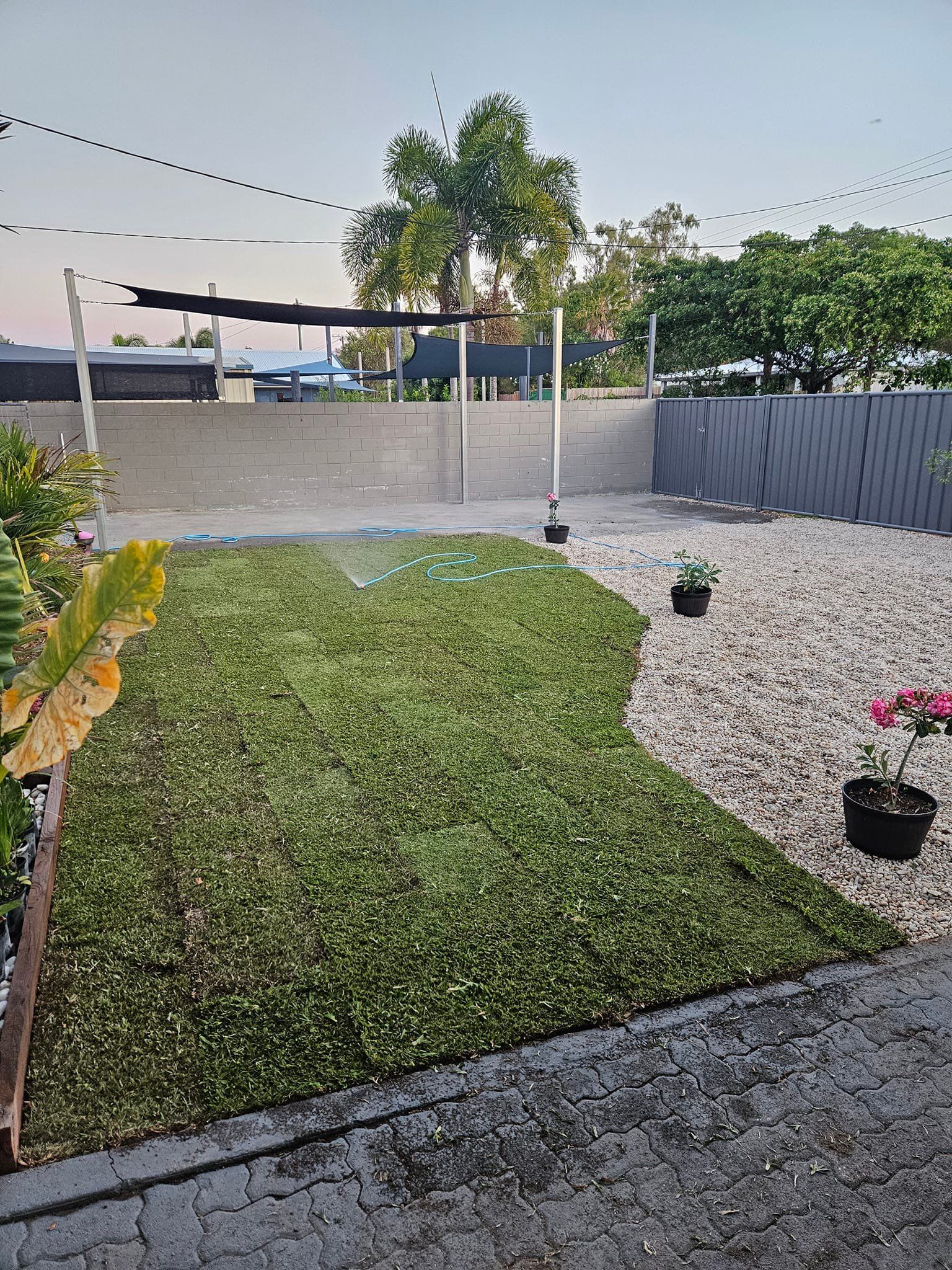 A Backyard With Green Turf and Gravel — AGM HIRE NQ in Kirwan, QLD