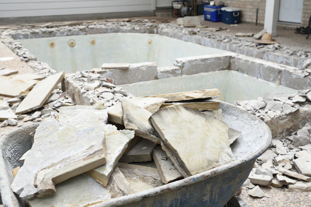 Wheelbarrow of Stone Pieces; Pool Under Construction — AGM HIRE NQ in Condon, QLD