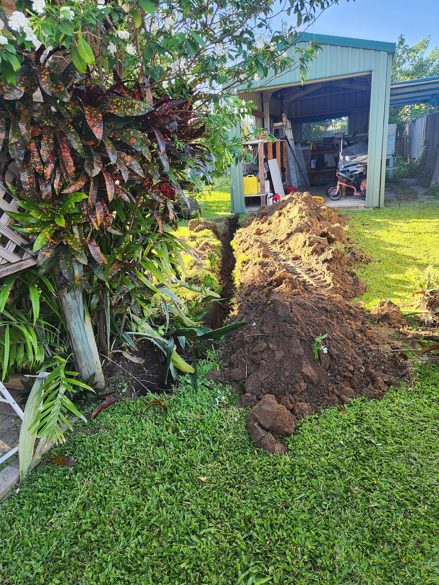 Trench Dug in a Grassy Yard — AGM HIRE NQ in Kirwan, QLD