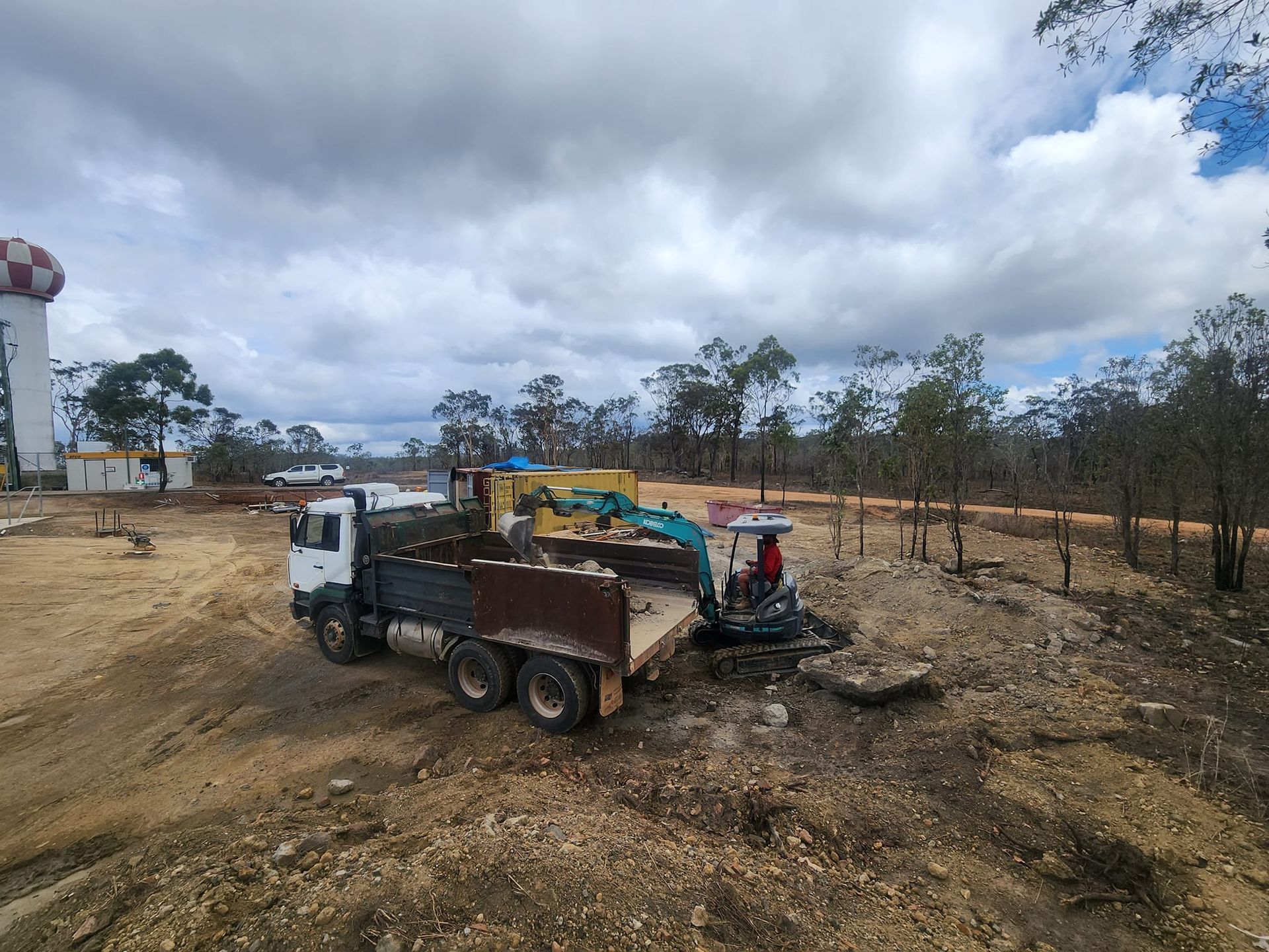 A Truck and Excavator at a Construction Site — AGM HIRE NQ in Condon, QLD