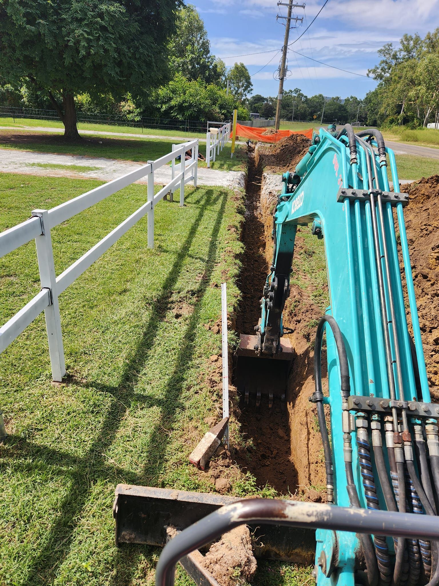 A Small Excavator Digging a Trench — AGM HIRE NQ in Kelso, QLD