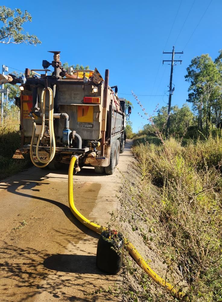 Truck With Yellow Hose on a Dirt Road, Pouring Liquid — AGM HIRE NQ in Condon, QLD