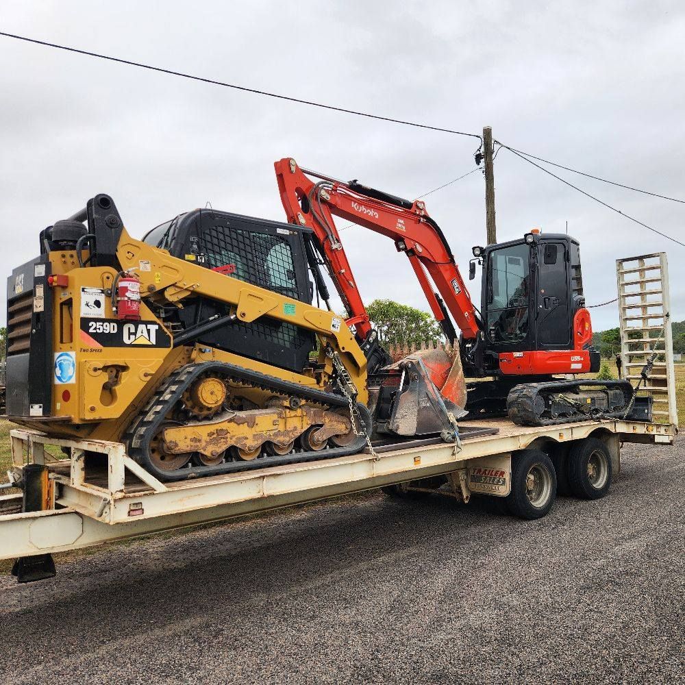 A Yellow Cat Skid Steer and Red Kubota Excavator on a Trailer — AGM HIRE NQ in Condon, QLD
