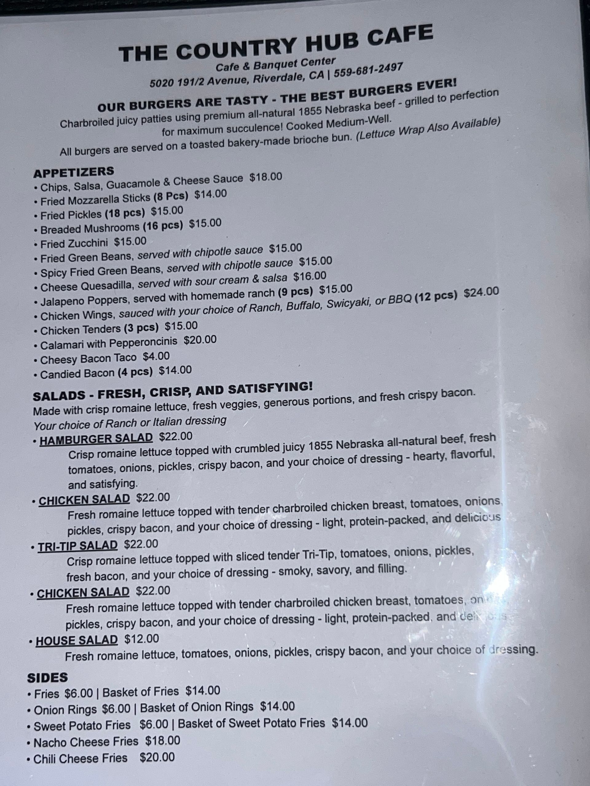 Blurry photo of a printed cafe menu titled “The Country Hub Cafe” on white paper