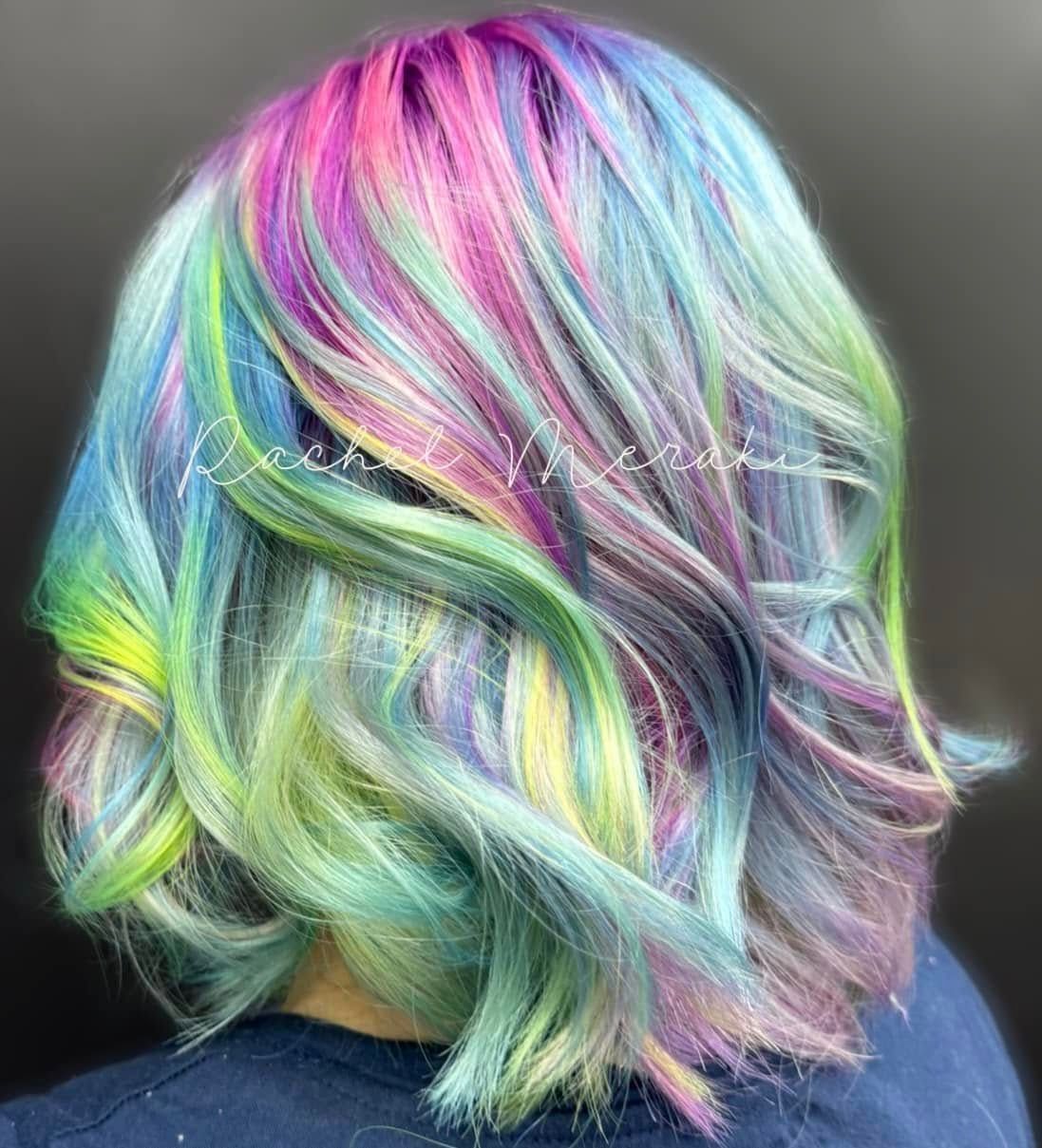 Pastel rainbow wavy bob haircut from the back against a gray background