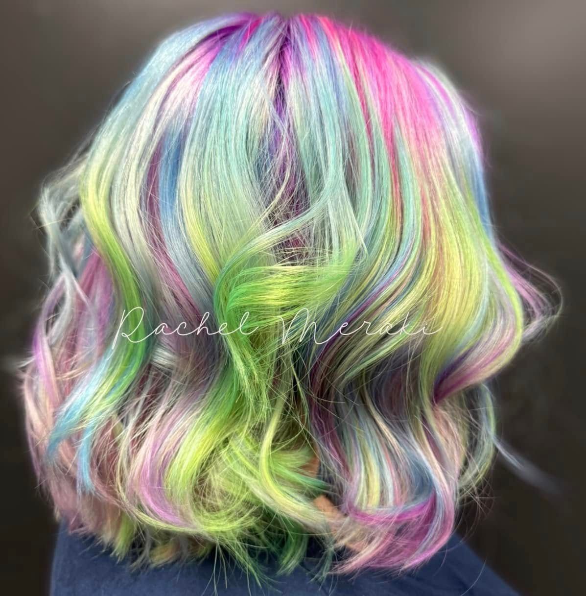 Pastel rainbow wavy bob haircut with pink, blue, green, and yellow highlights