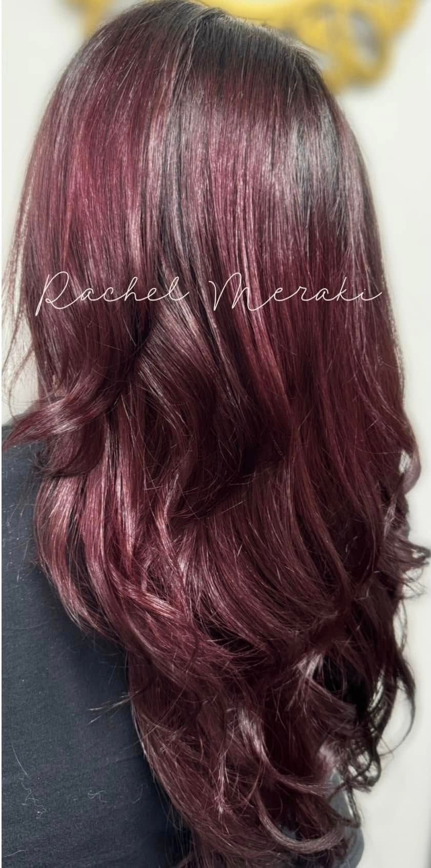 Long wavy burgundy hair styled in loose curls, viewed from the back.