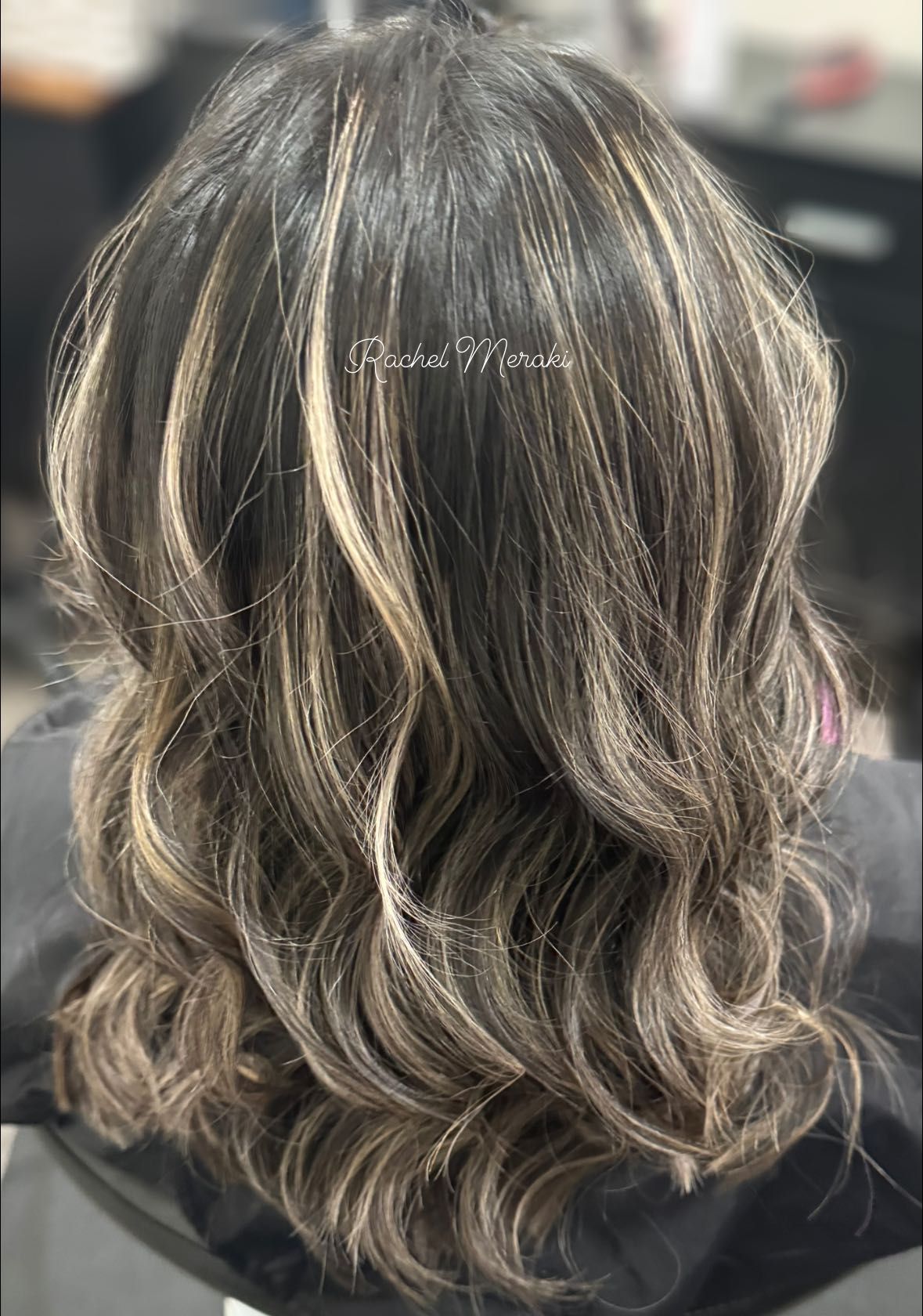 Wavy shoulder-length brown hair with blonde highlights, viewed from the back.