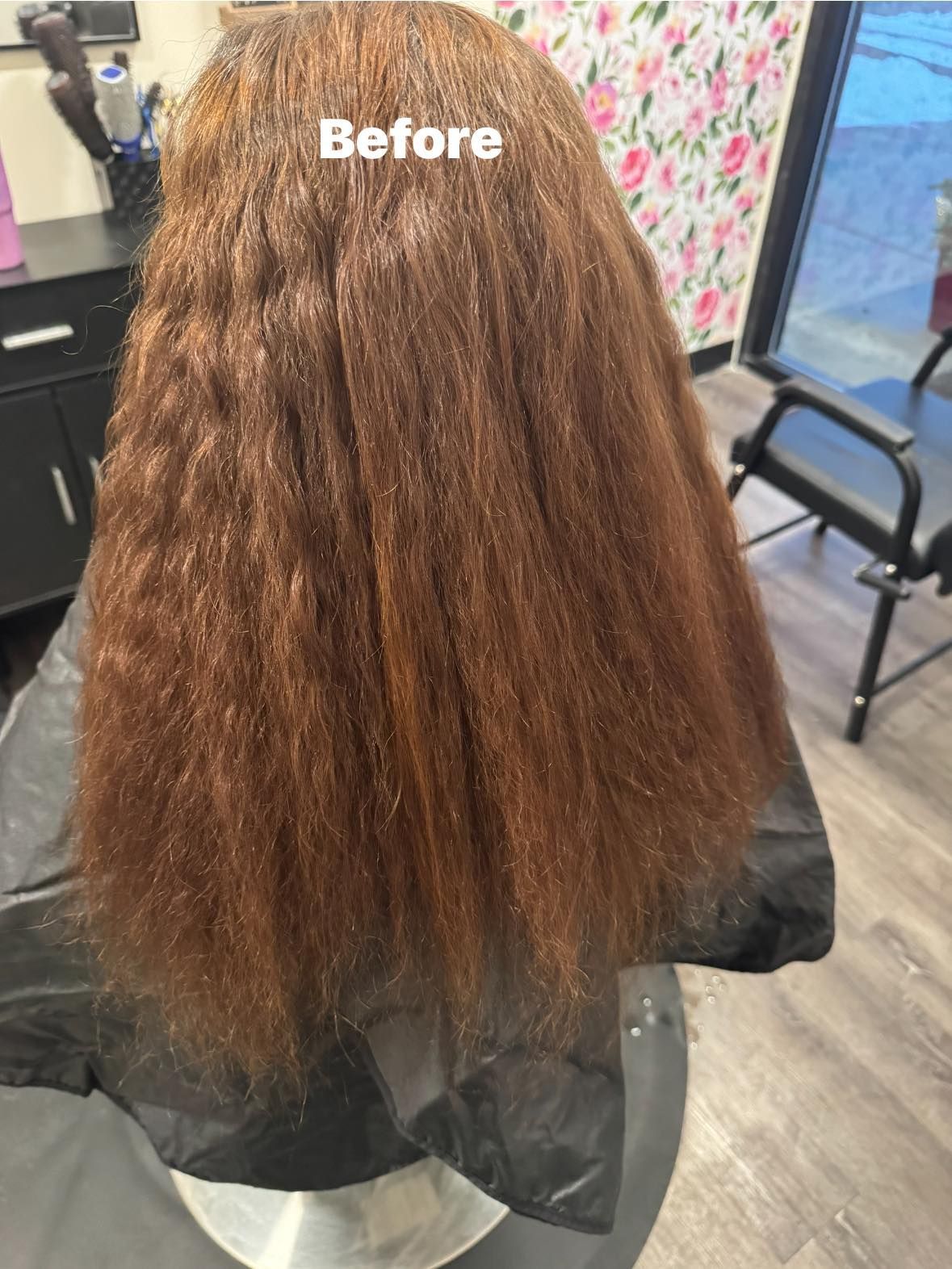 Back view of a client with long curly auburn hair in a salon chair, labeled “Before.”