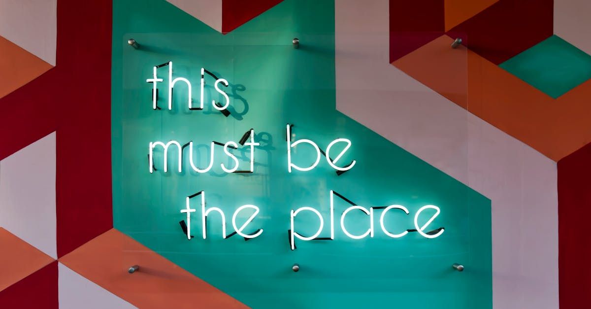 A neon sign on a wall that says `` this must be the place ''.