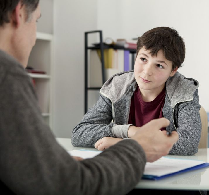 A Young Man With a Smile Paints Green on a White Table — Bright Day Psychology in Pialba, QLD