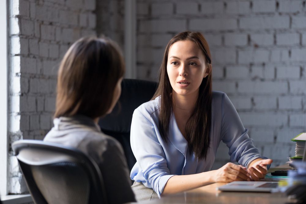Two Women at a Desk Having a Talk — Bright Day Psychology in Pialba, QLD