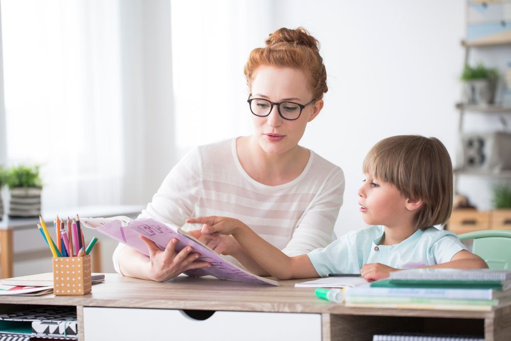 Woman With Glasses Pointing at a Worksheet — Bright Day Psychology in Pialba, QLD