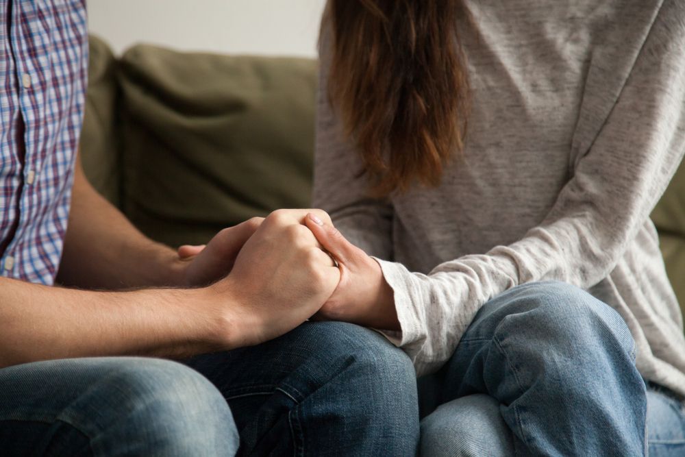 Holding Hands on a Couch Offering Comfort and Support — Bright Day Psychology in Pialba, QLD
