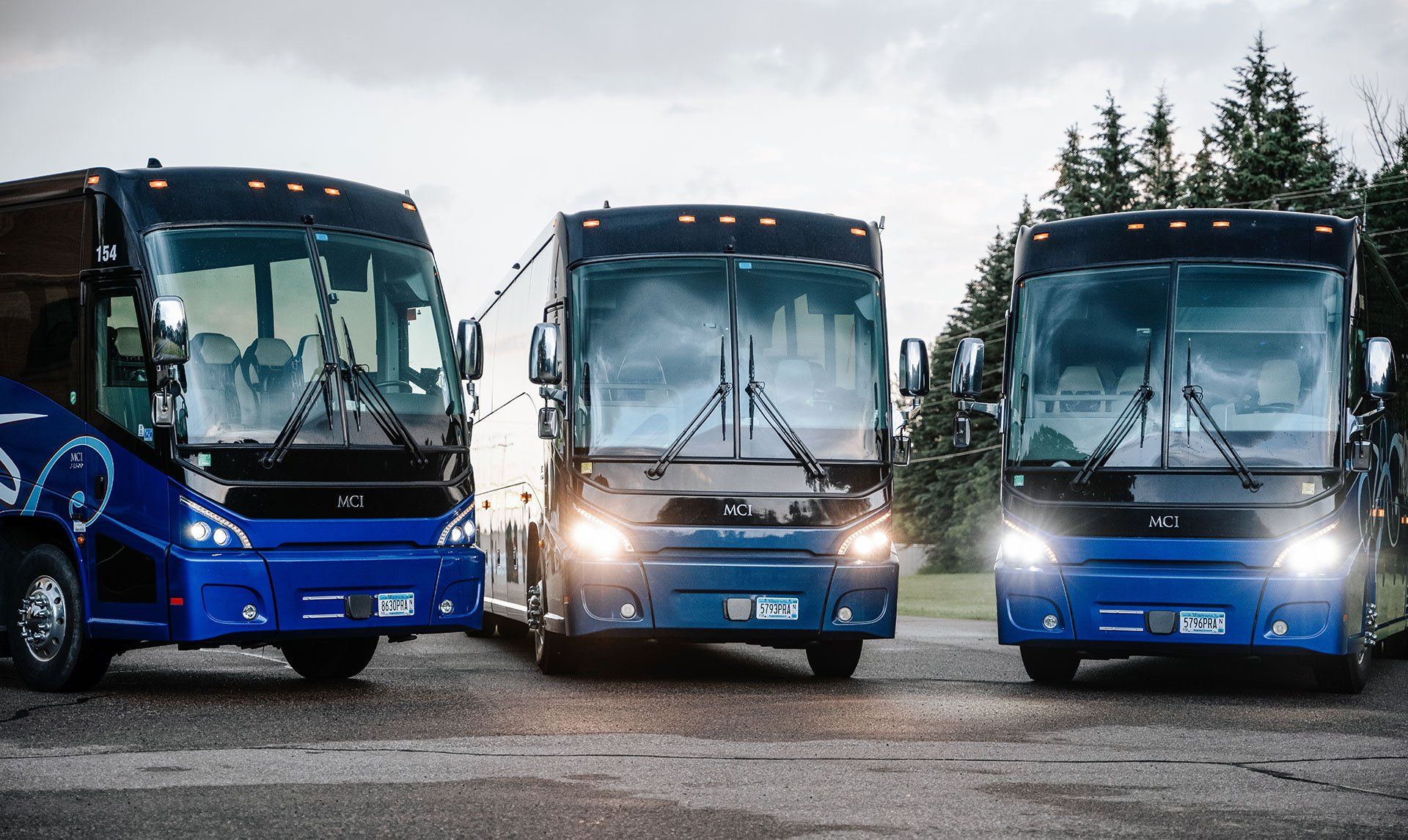 A Row of Three Blue Deluxe Motor Coaches, Each Seating 38 Passengers, Parked in St. Cloud, MN