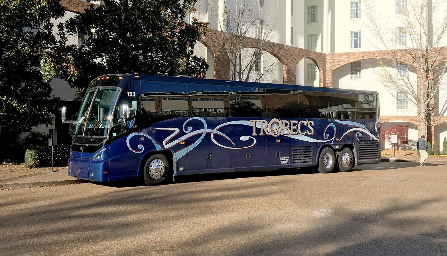 A Blue Motorcoach Parked Outside a Building for Corporate Event Transportation in St. Cloud, MN