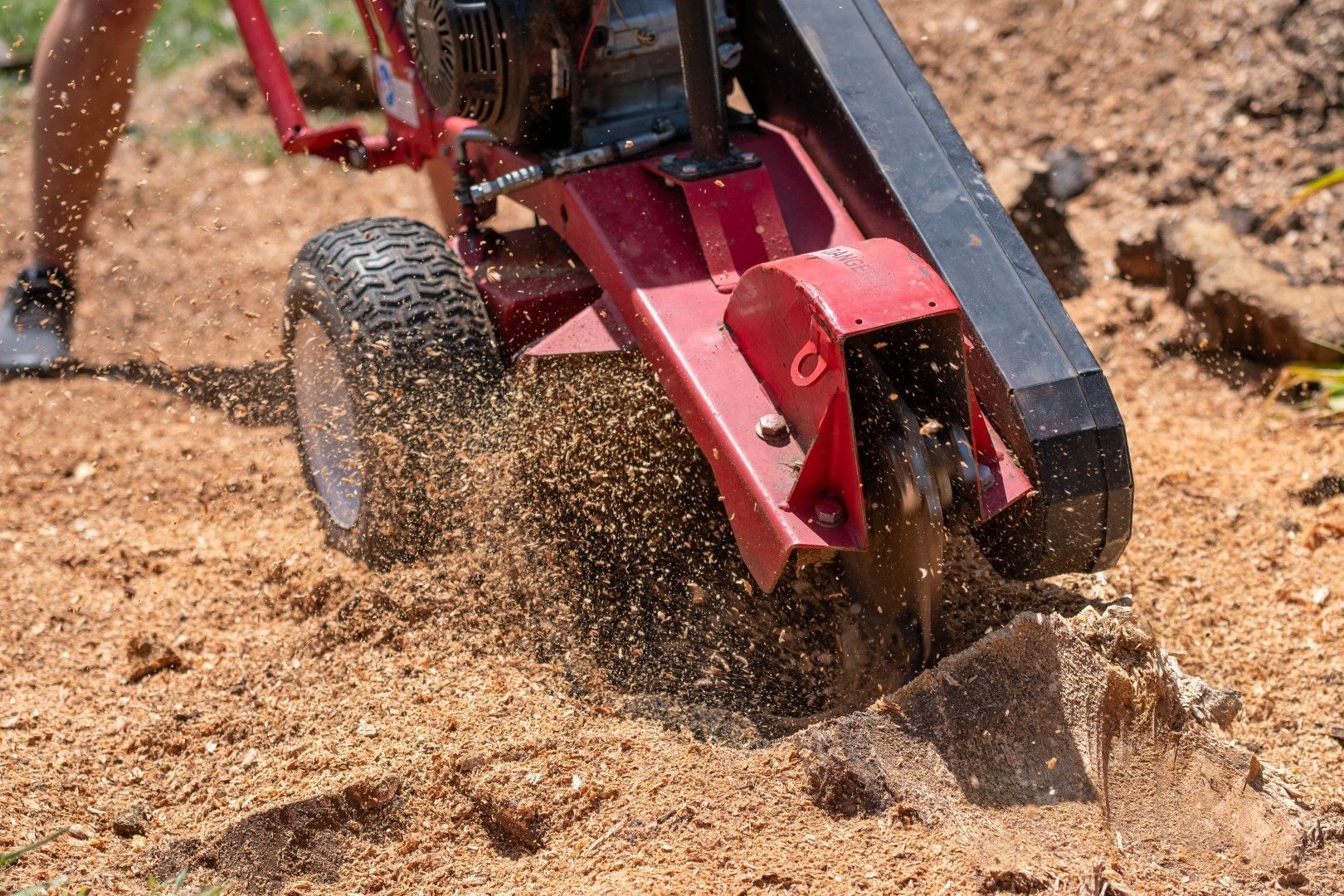 Red off-road RC car kicking up sand on a dirt track