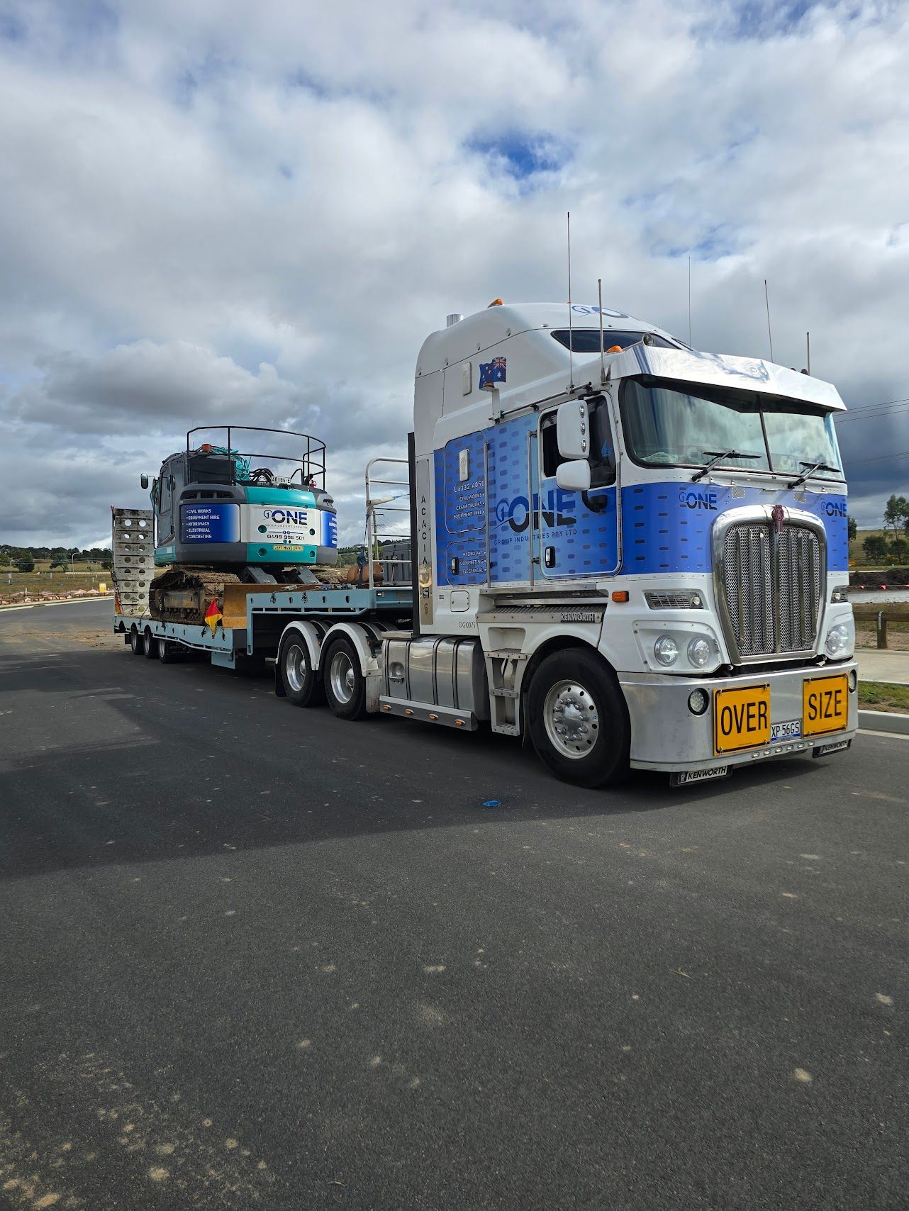 Semi-truck transporting a mini excavator on a lowboy trailer — One Group Industries Pty Ltd in Bathurst, NSW