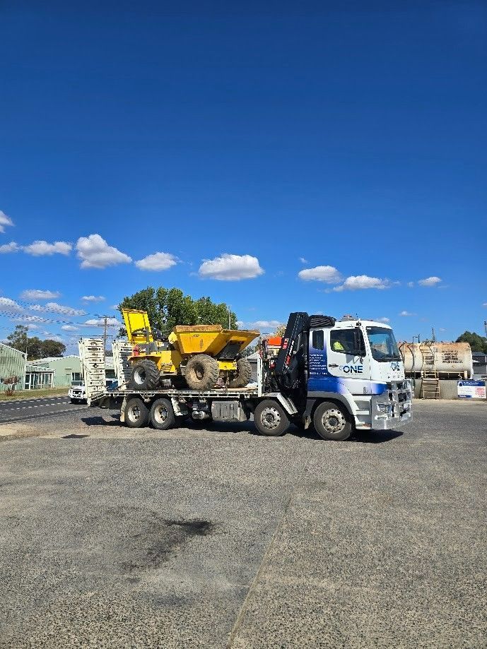 A Flatbed Truck Carrying Construction Equipment — One Group Industries Pty Ltd in Bathurst, NSW
