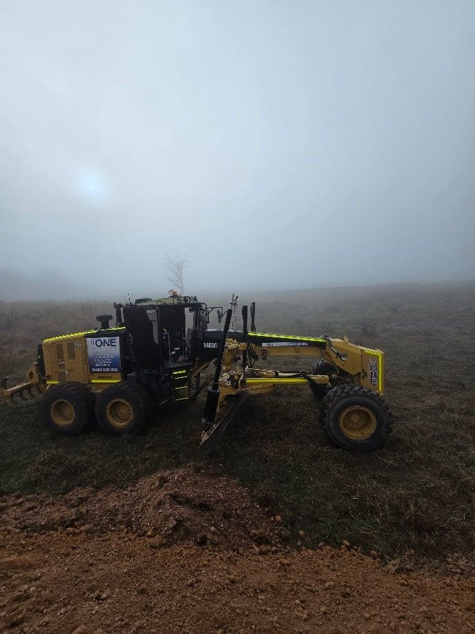 Yellow Motor Grader on A Construction Site — One Group Industries Pty Ltd in Bathurst, NSW