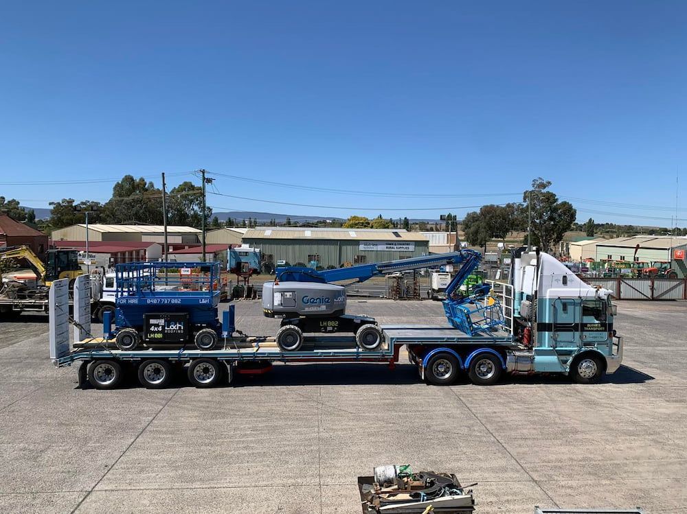 A Semi Truck is Carrying a Crane on a Flatbed Trailer — One Group Industries Pty Ltd in Bathurst, NSW