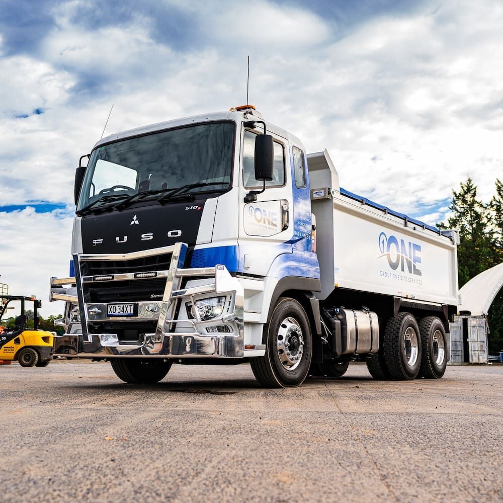 A Dump Truck is Parked in a Parking Lot — One Group Industries Pty Ltd in Bathurst, NSW
