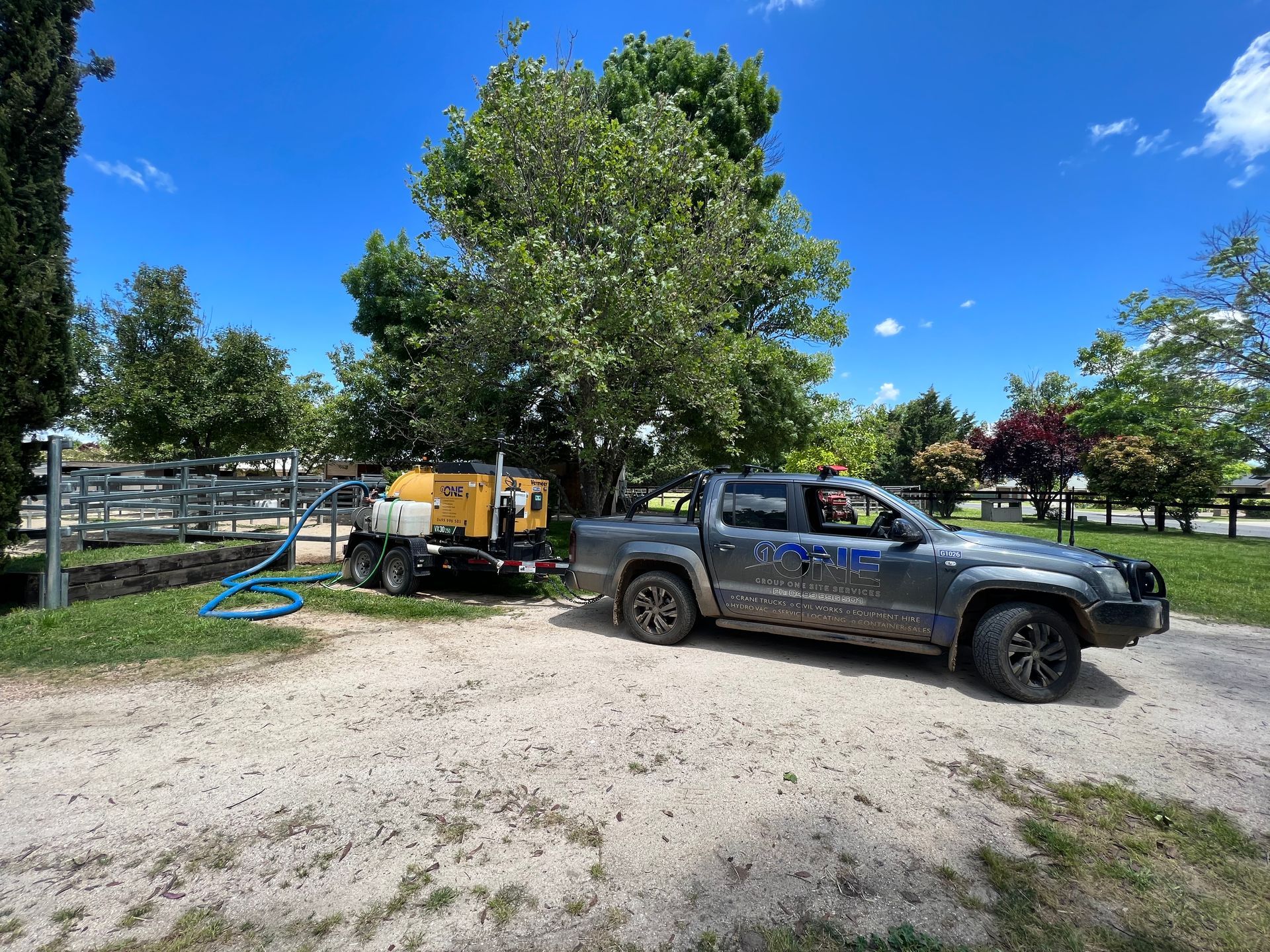 A Truck With a Trailer Attached to It is Parked in a Dirt Lot — One Group Industries Pty Ltd in Bathurst, NSW