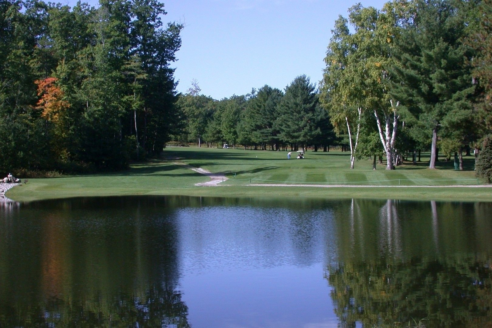 A golf course with a lake in the middle of it