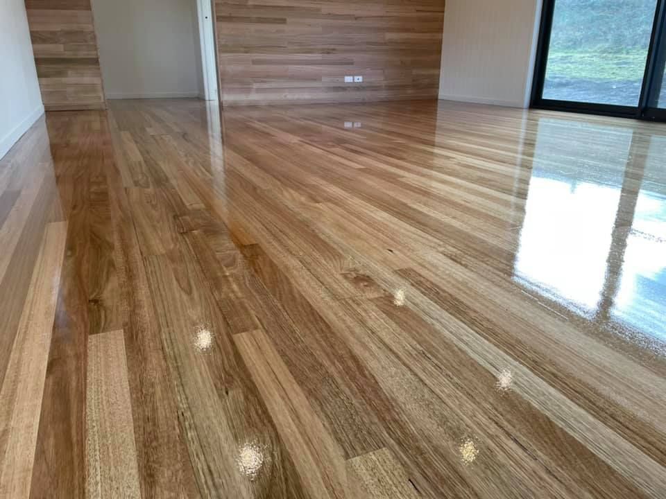 Glossy, Light-toned Wooden Floorboards Extending Into a Room — Finer Floors In Warrane, TAS