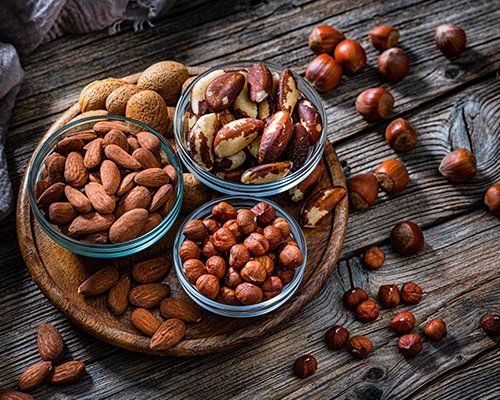 Nuts on Dark Rustic Table — Honolulu, HI — Taiyo Inc
