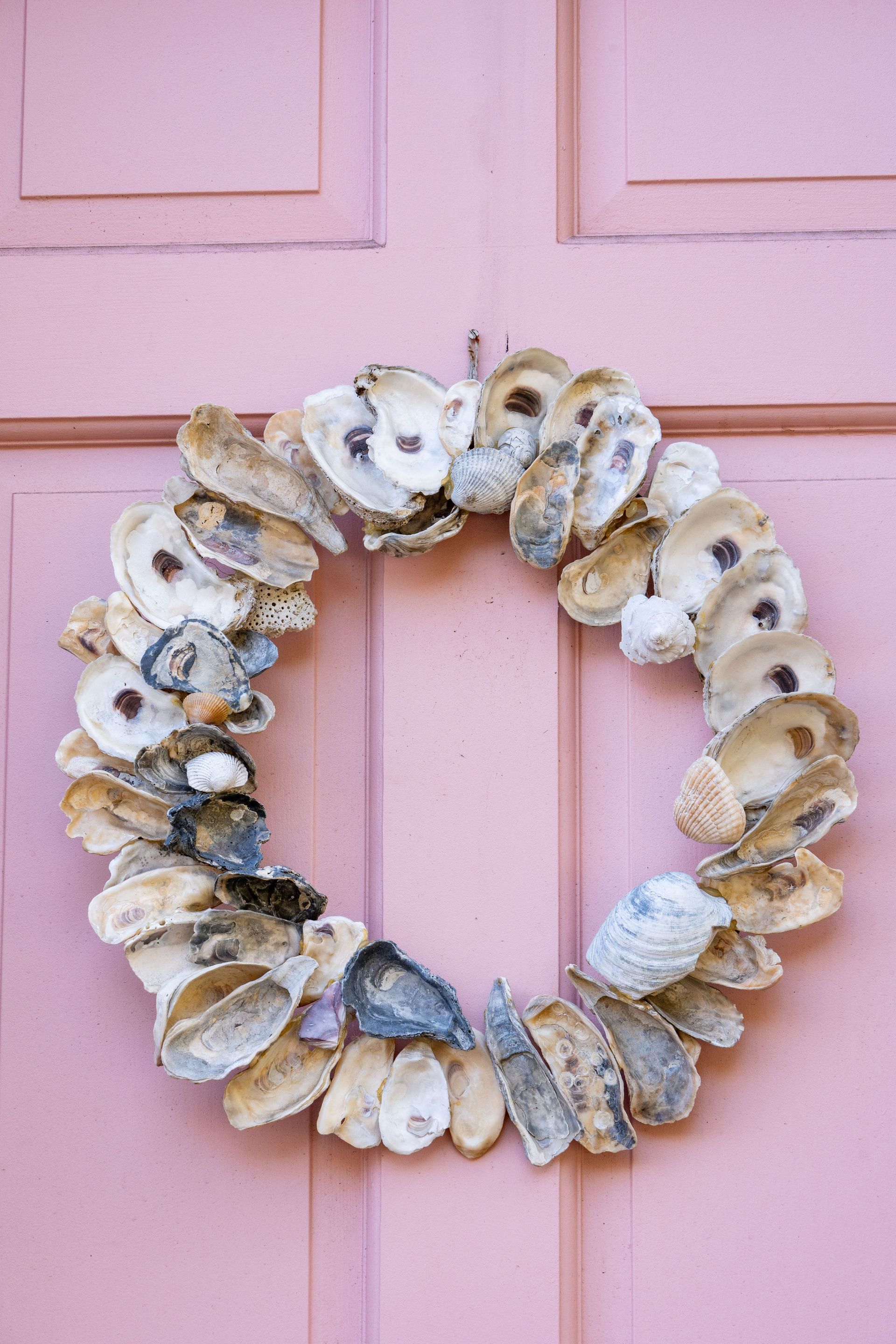 Oyster shell wreath on a pink door