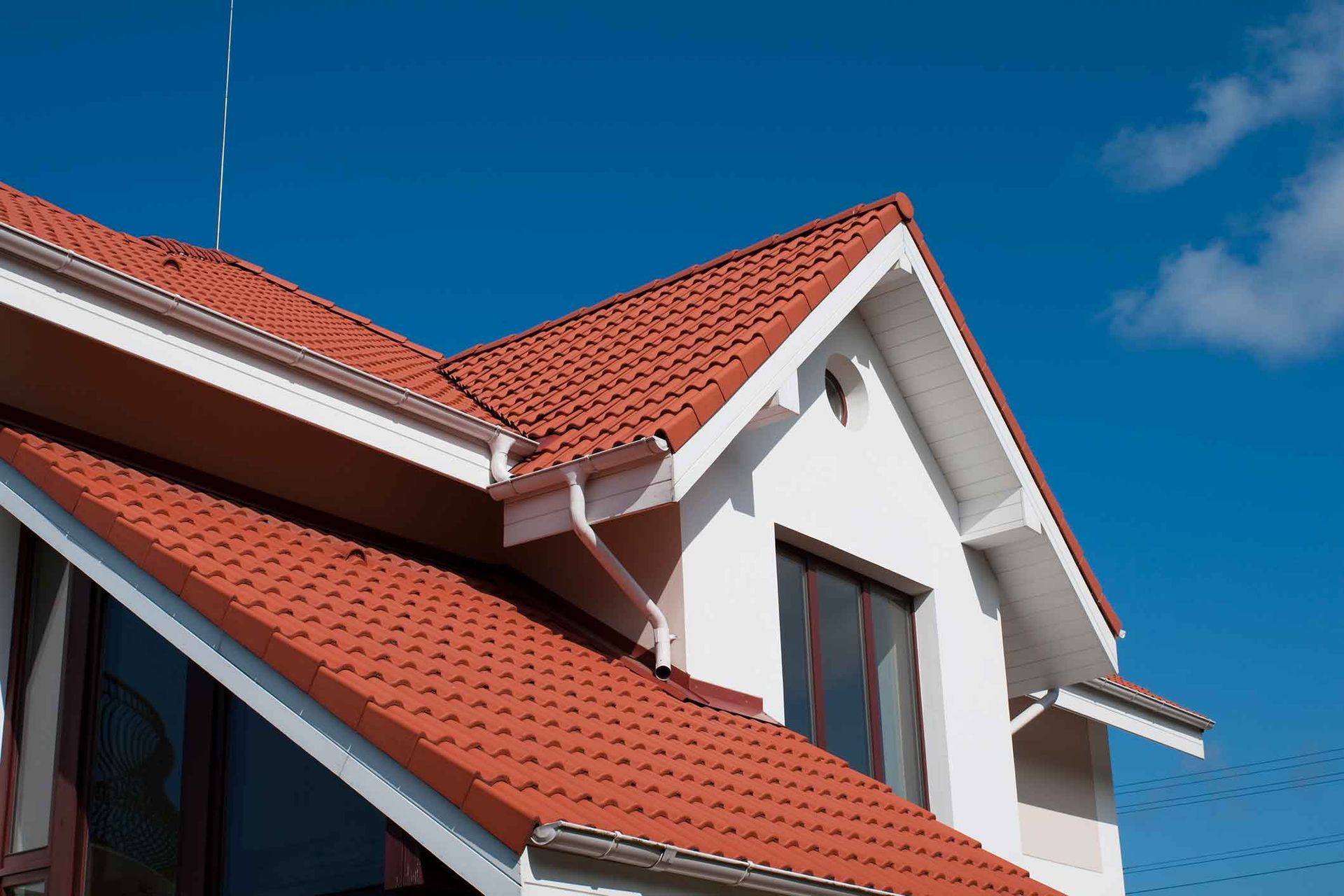A white house with a red tiled roof