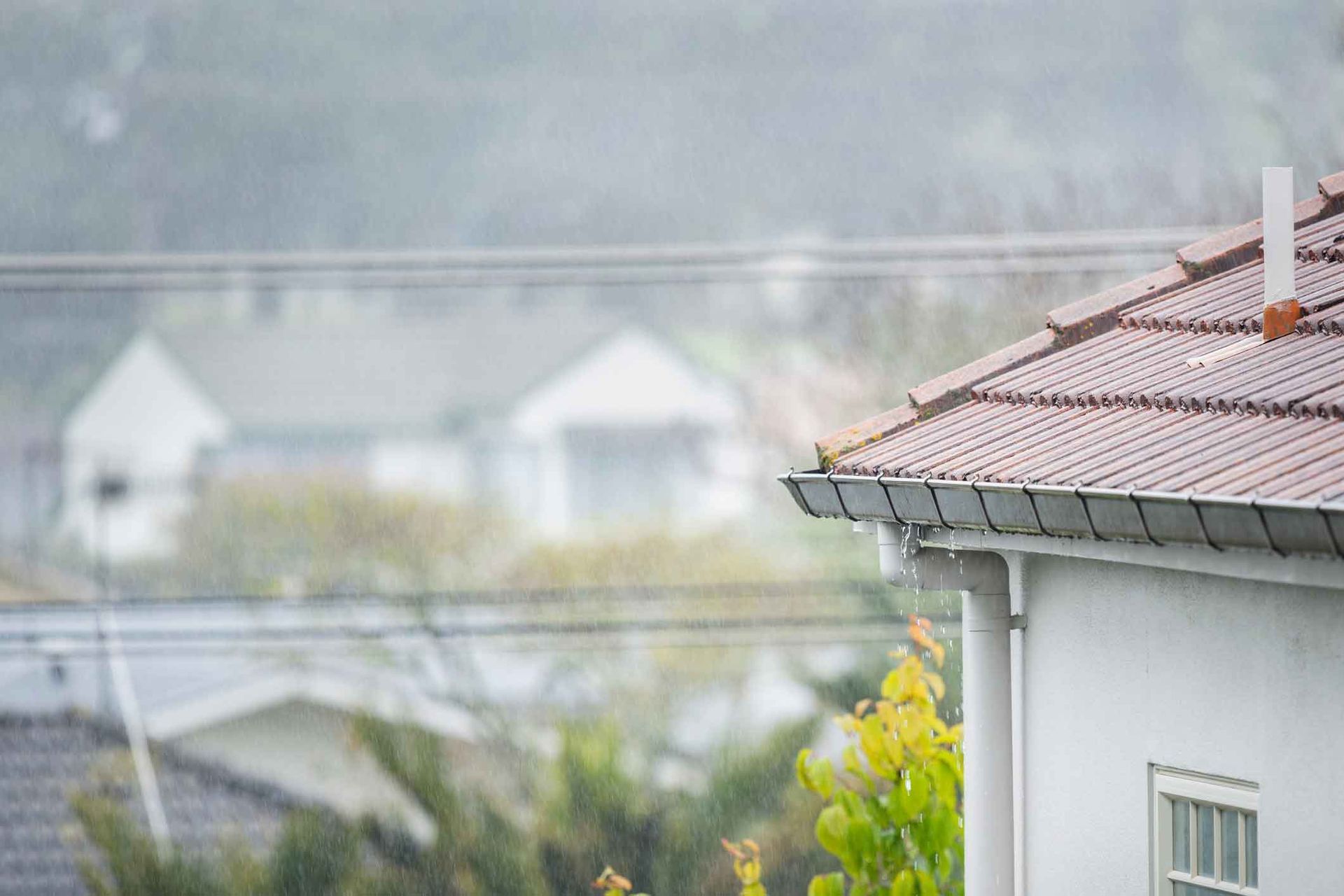 A house with a roof that is covered in rain.