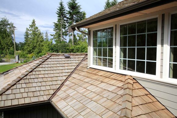 A house with a wooden roof and two windows