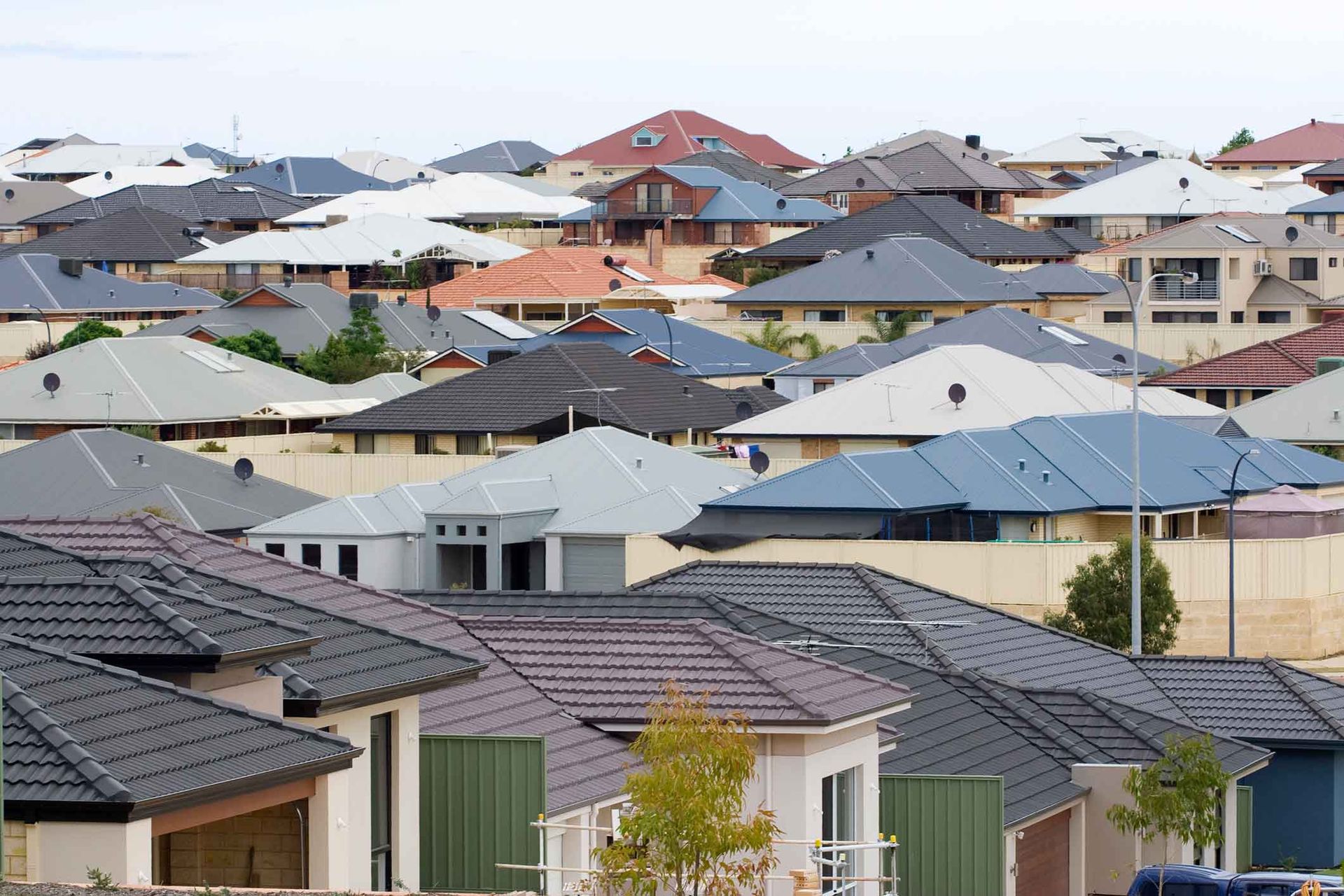 A row of houses with tiled roofs in a residential area