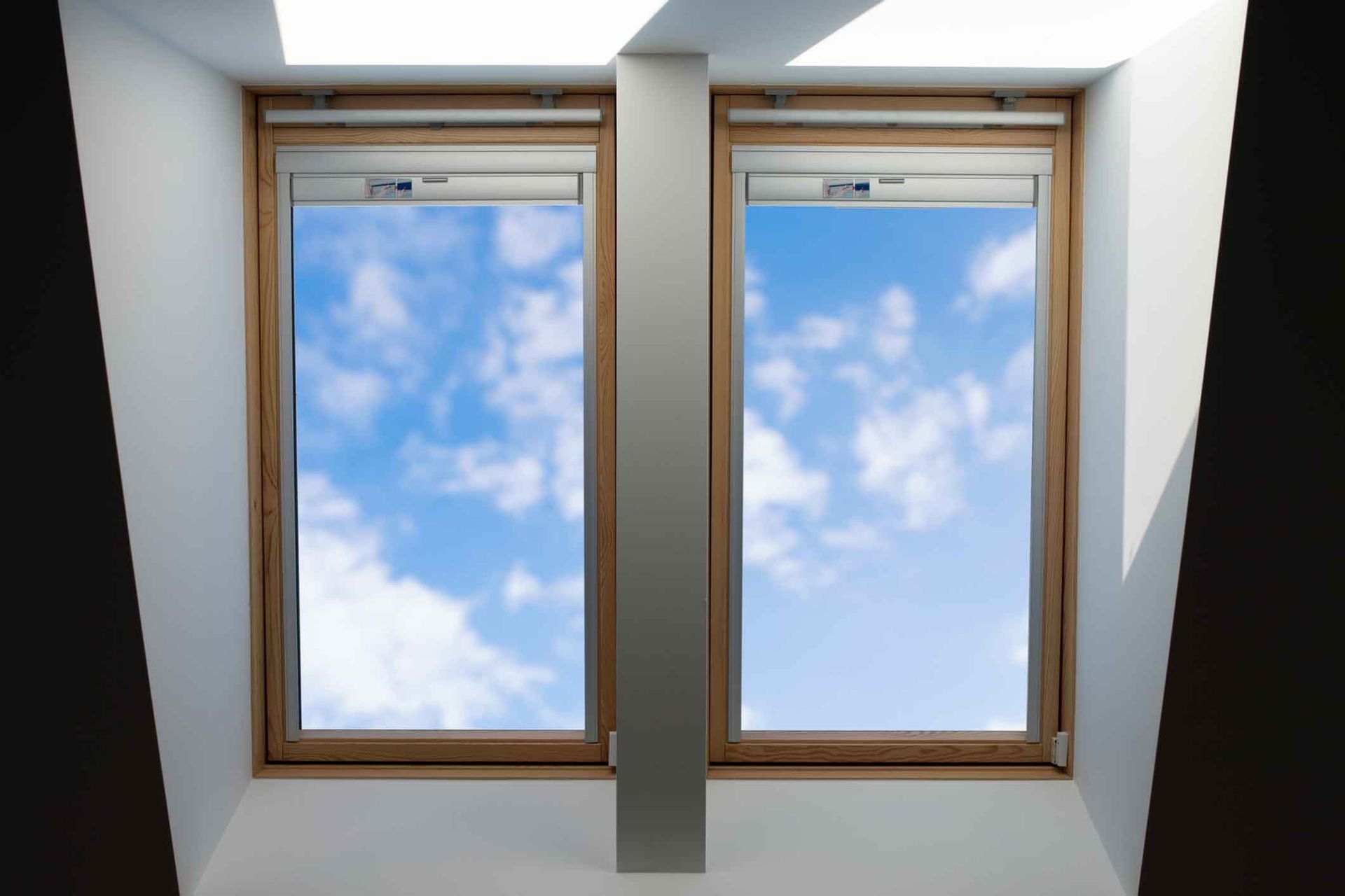 The sky is visible through the windows of the attic