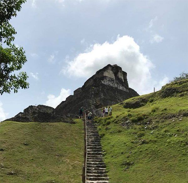 Stairs leading up to a hill with a mountain in the background