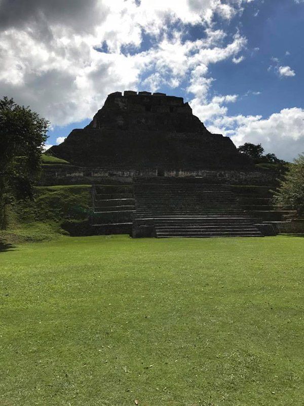 A large grassy field with a pyramid in the background.