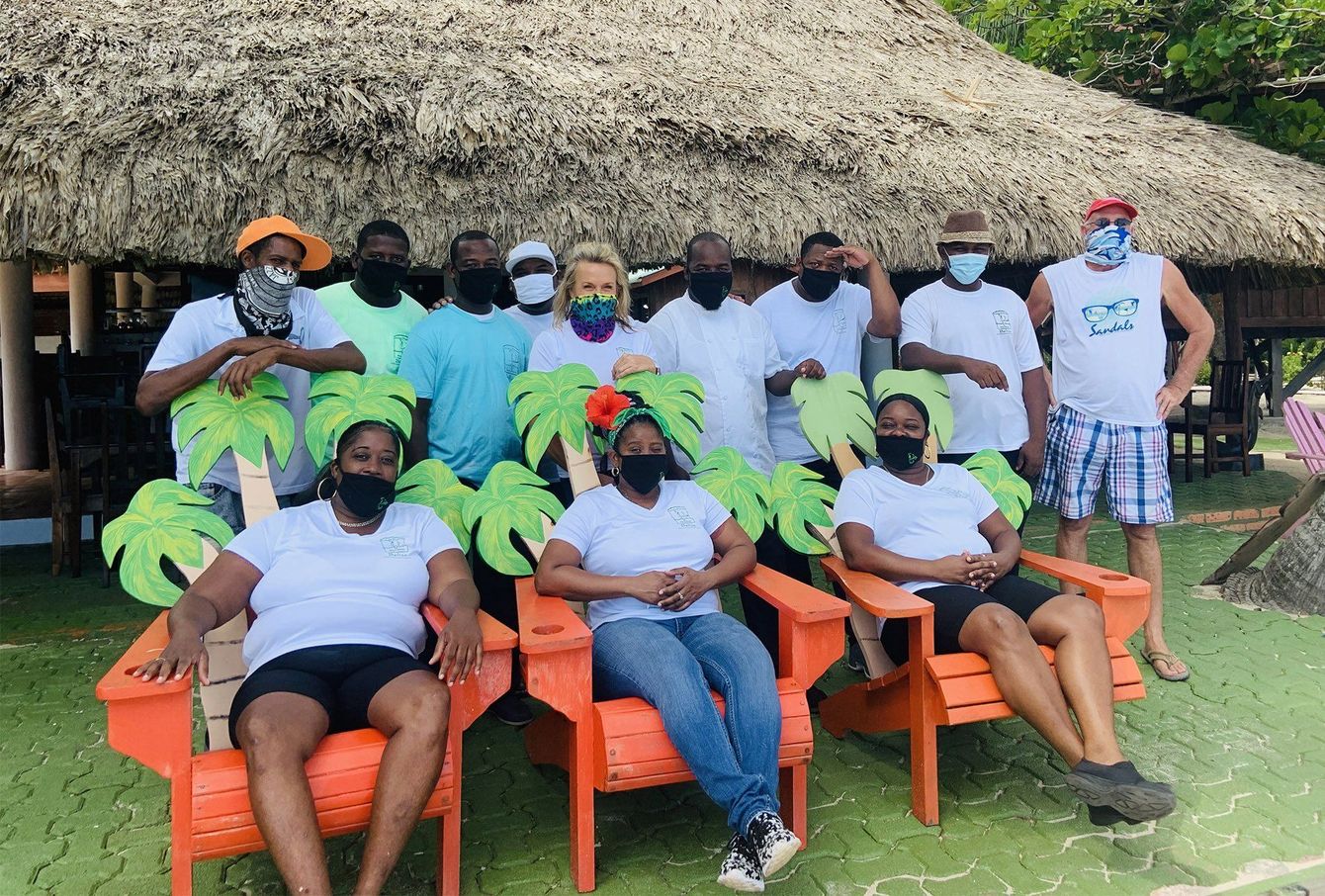 A group of people wearing masks are posing for a picture.
