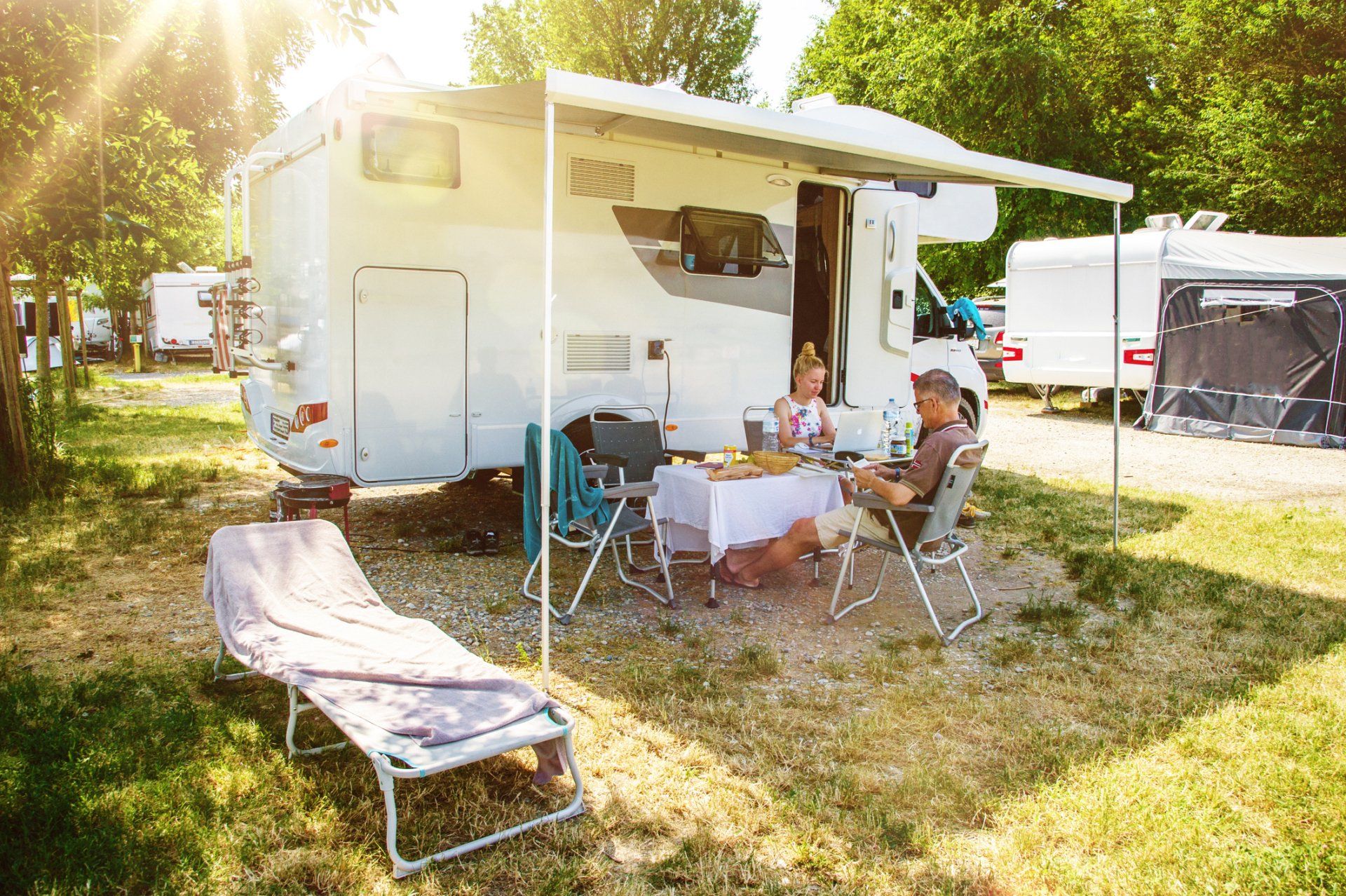 Couple In Front Of Motorhome — Davis, OK — KV Mobile RV Park
