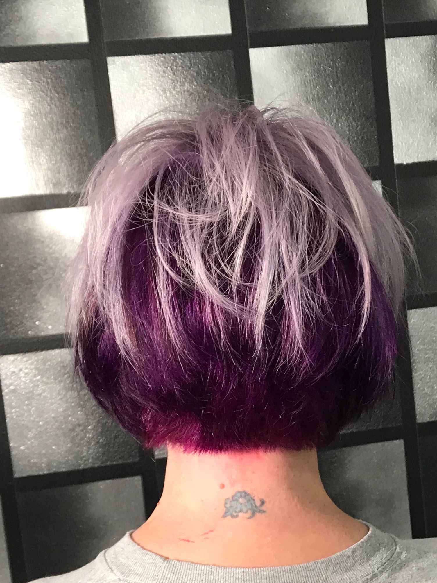 A stacked bob with platinum blond top and a vivid, deep purple underneath.