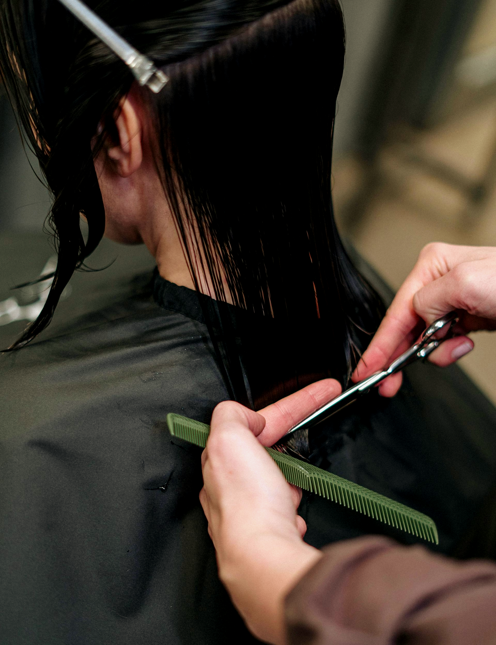 A woman getting her ends trimmed