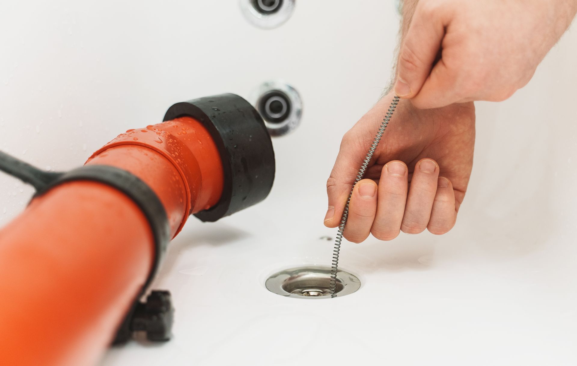 Using tools to clear a drain